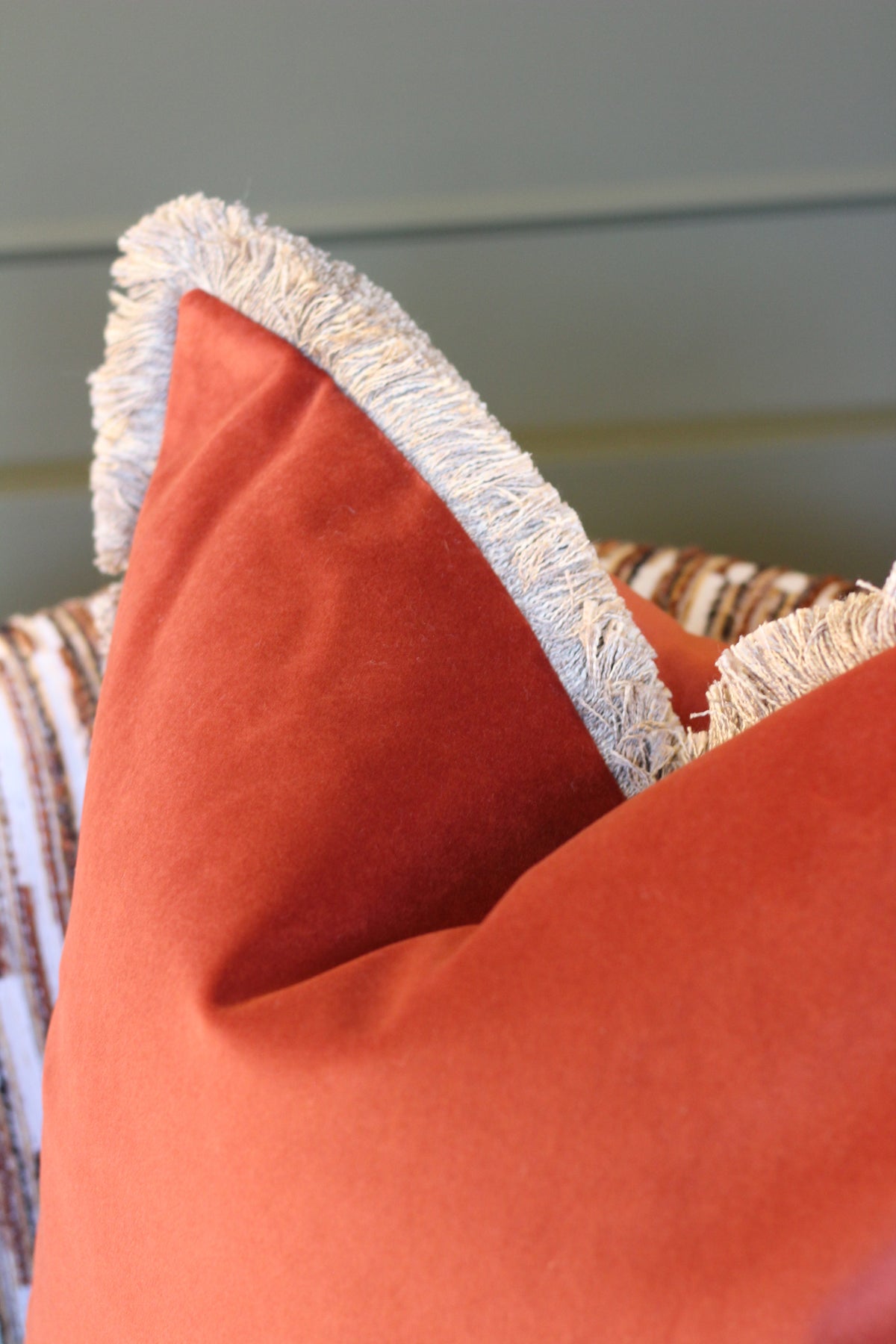 Langford Rust fringed velvet cushion in a warm rust tone, 55 x 55cm