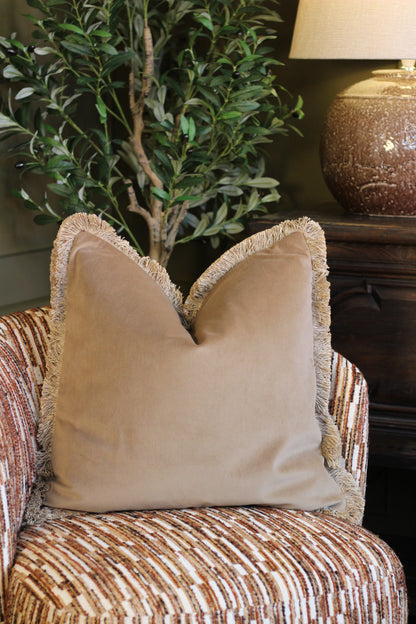 Langford Stone fringed velvet cushion in a warm neutral tone, 55 x 55cm