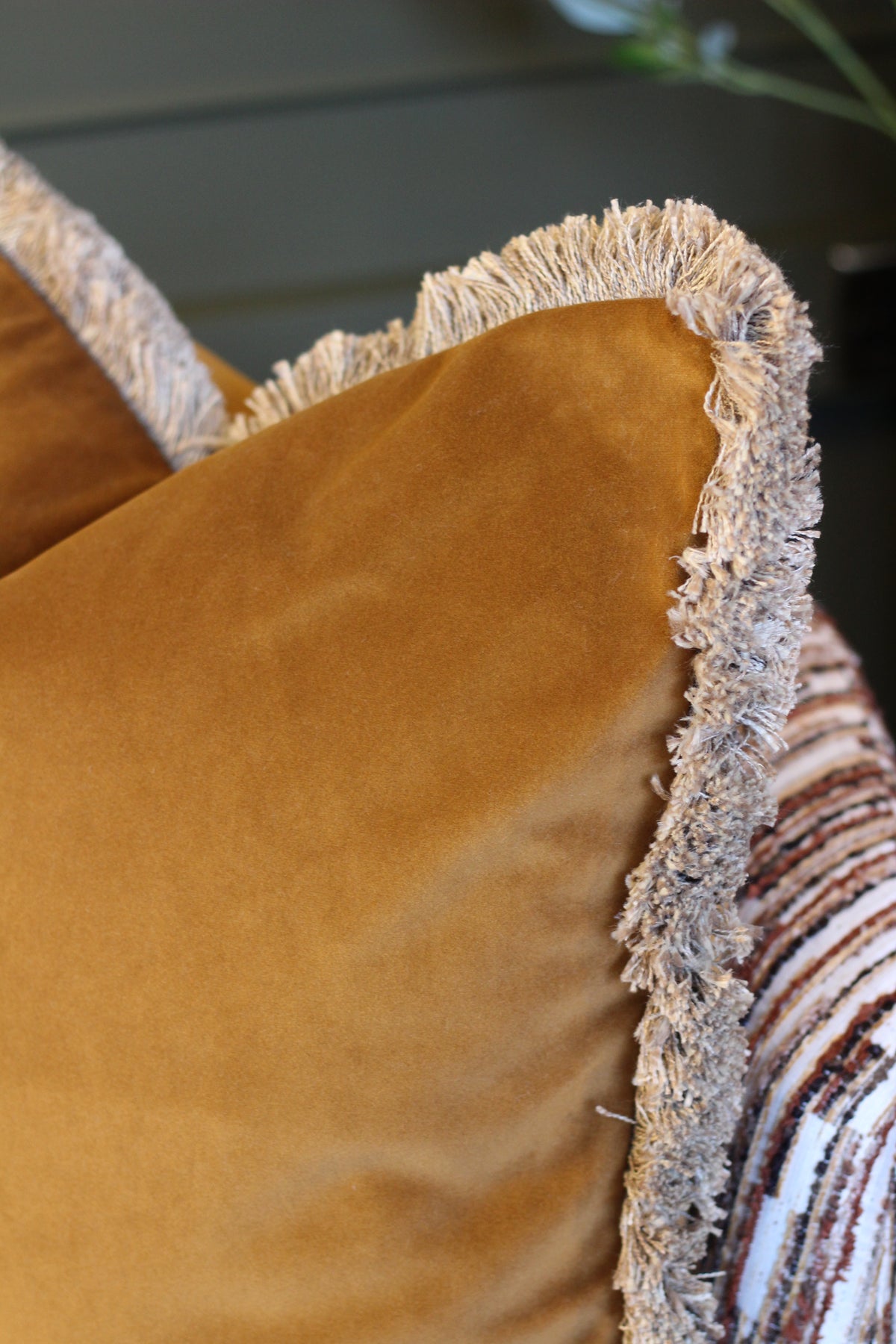 Langford Whiskey fringed velvet cushion in a warm whiskey tone, 55 x 55cm