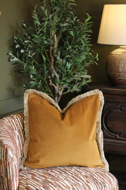Langford Whiskey fringed velvet cushion in a warm whiskey tone, 55 x 55cm