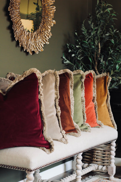 Langford Stone fringed velvet cushion in a warm neutral tone, 55 x 55cm