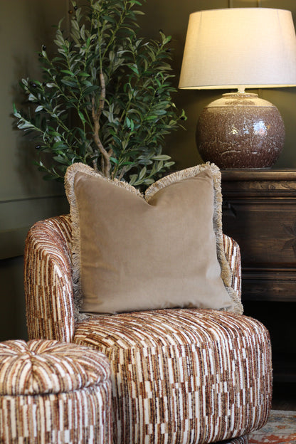 Langford Stone fringed velvet cushion in a warm neutral tone, 55 x 55cm