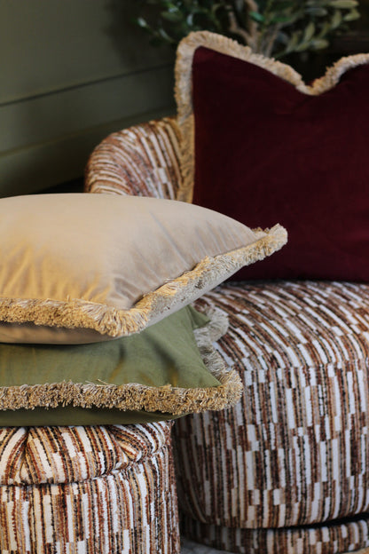 Langford Stone fringed velvet cushion in a warm neutral tone, 55 x 55cm