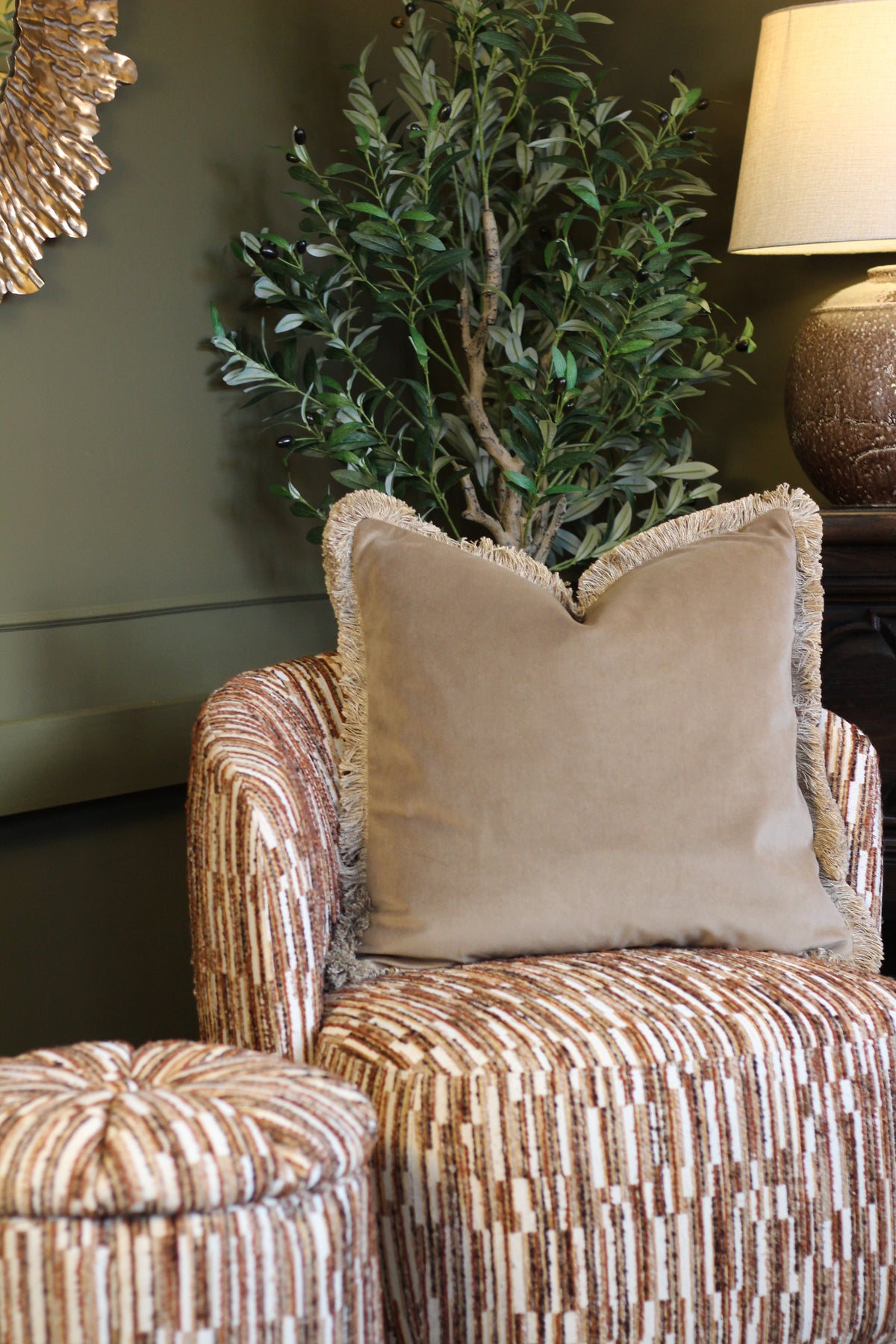 Langford Stone fringed velvet cushion in a warm neutral tone, 55 x 55cm