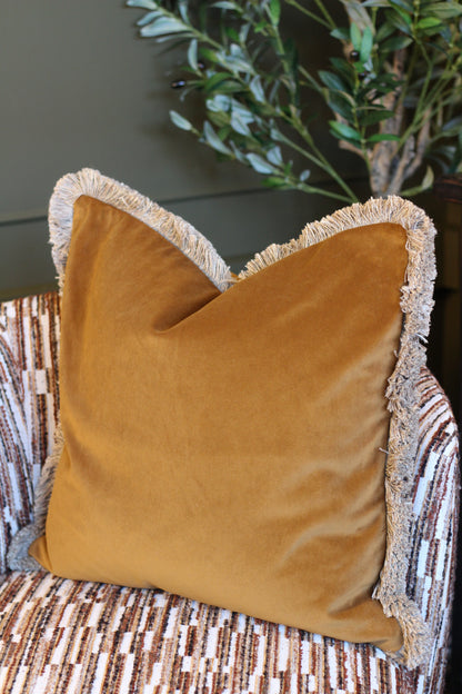 Langford Whiskey fringed velvet cushion in a warm whiskey tone, 55 x 55cm