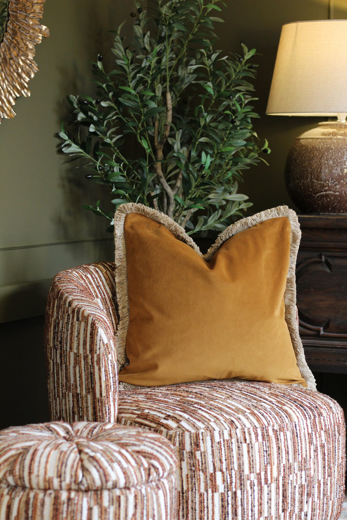Langford Whiskey fringed velvet cushion in a warm whiskey tone, 55 x 55cm