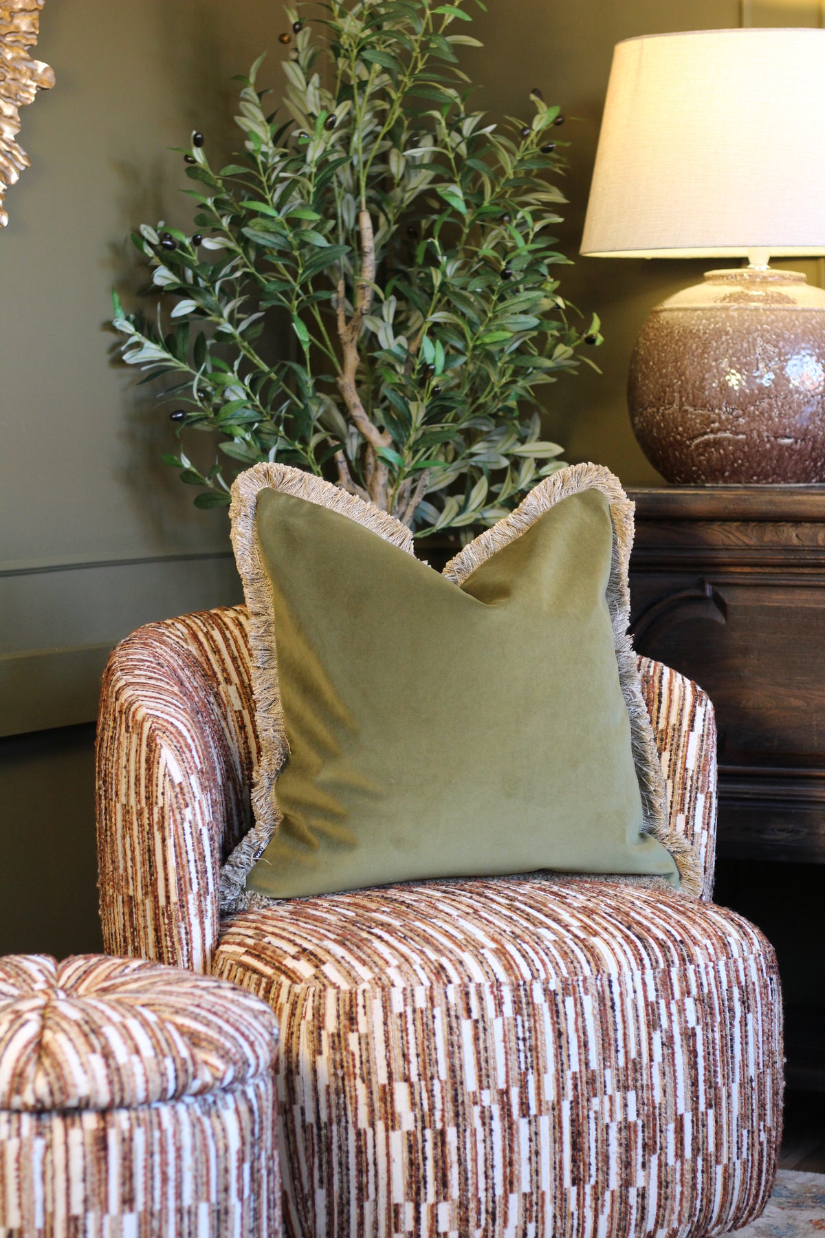Langford Olive fringed velvet cushion in an earthy olive green, 55 x 55cm