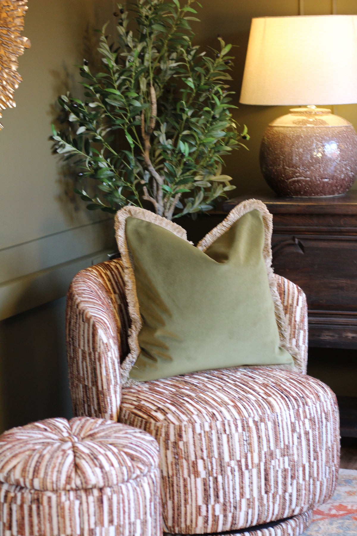Langford Olive fringed velvet cushion in an earthy olive green, 55 x 55cm