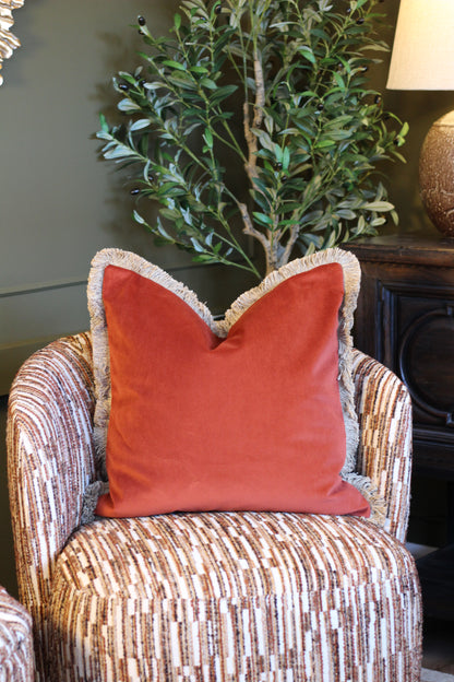 Langford Rust fringed velvet cushion in a warm rust tone, 55 x 55cm