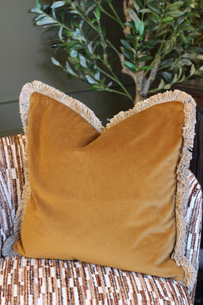 Langford Whiskey fringed velvet cushion in a warm whiskey tone, 55 x 55cm