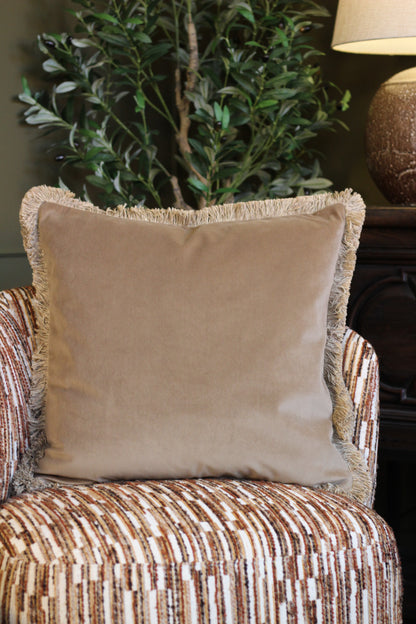 Langford Stone fringed velvet cushion in a warm neutral tone, 55 x 55cm