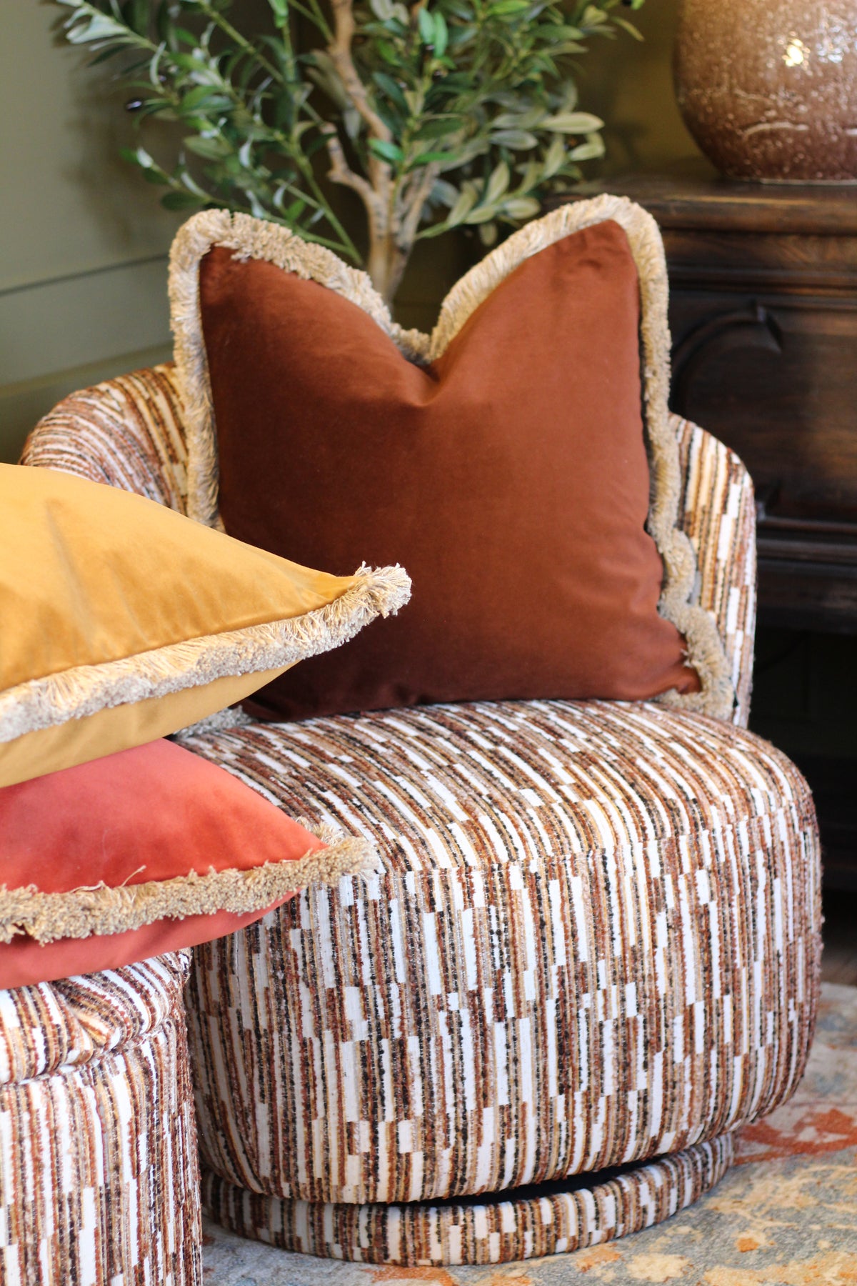 Langford Whiskey fringed velvet cushion in a warm whiskey tone, 55 x 55cm