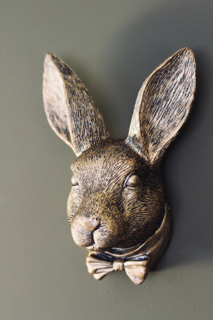 Antique gold rabbit wall bust with bow tie, angled side view