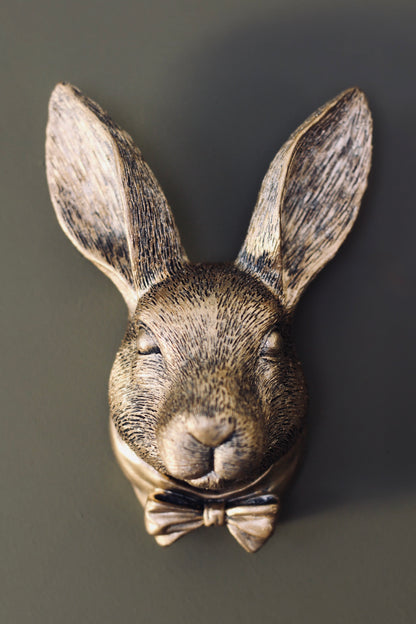 Small antique gold rabbit wall bust with bow tie, front view