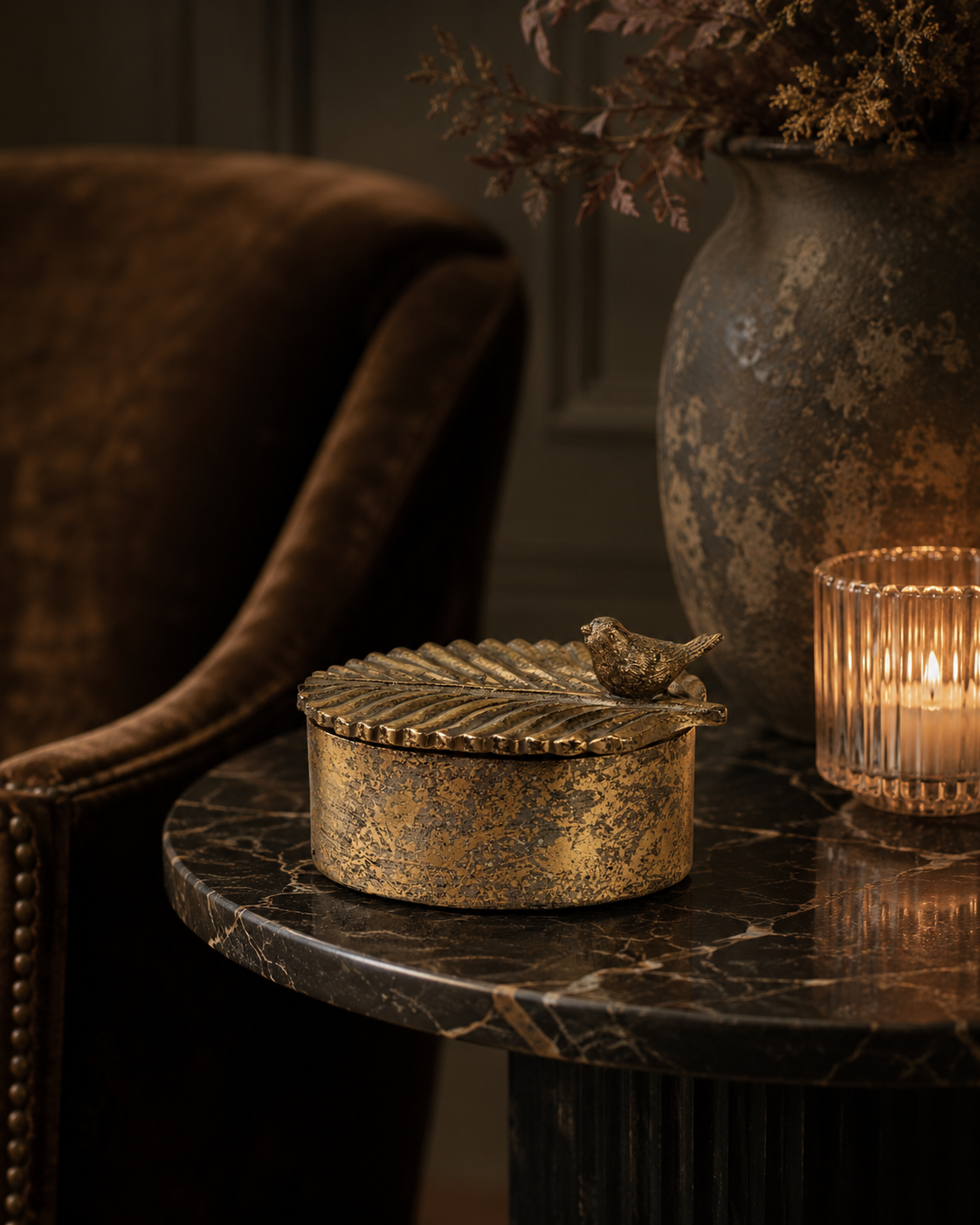 Side view of the antique gold bird trinket box with textured detailing.