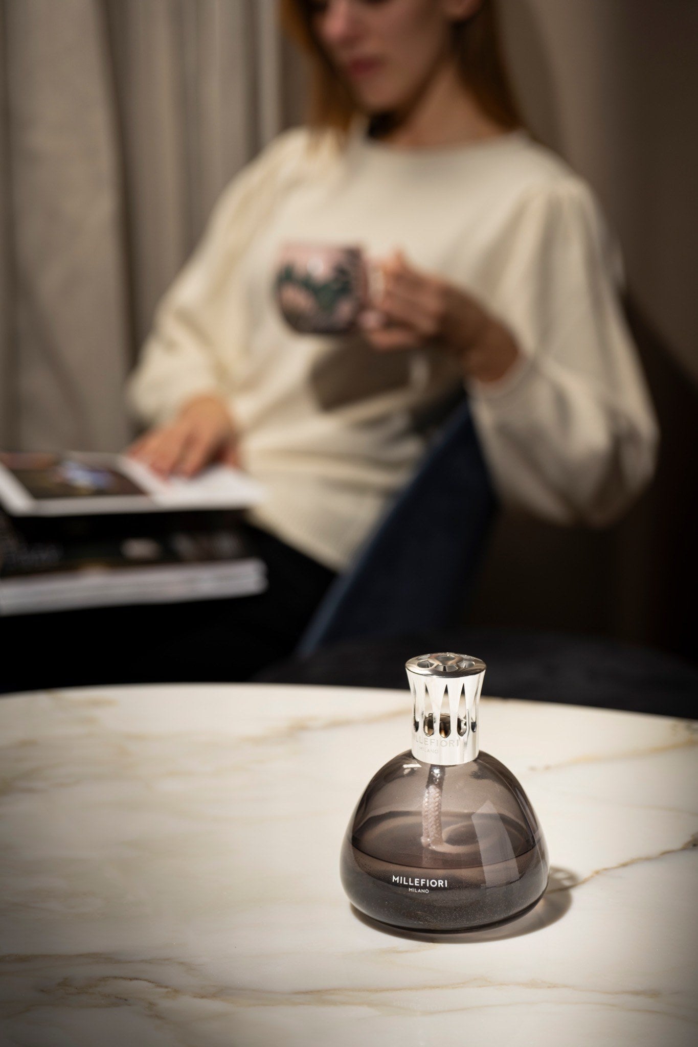 Millefiori Smokey Grey Fragrance Lamp lifestyle image on marble table